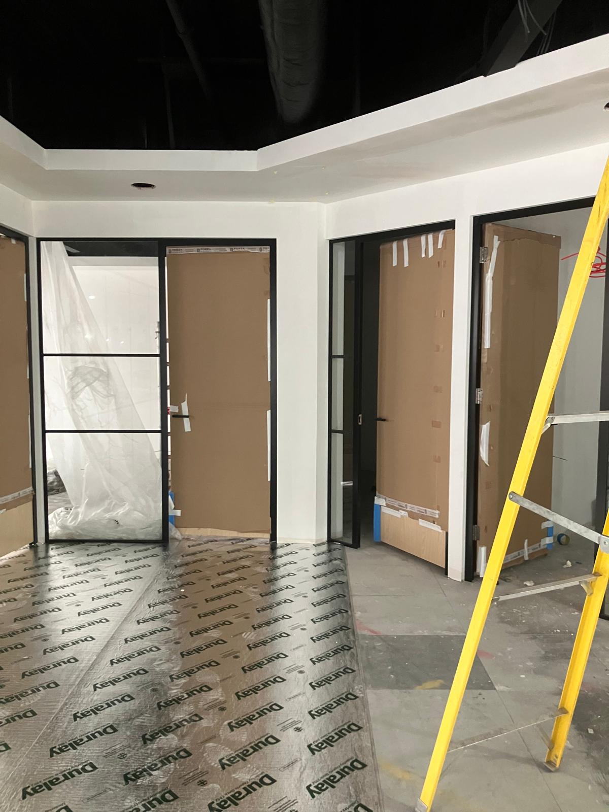 Glass partition doors with protected floors